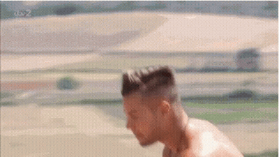 Shirtless Man With Head Down In Field GIF