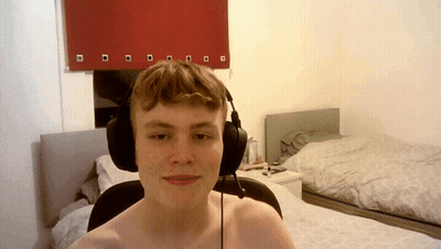 Shirtless Man With Headphones Beside Bed GIF