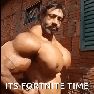 Shirtless Man With Huge Muscles In Front Of Brick Building GIF