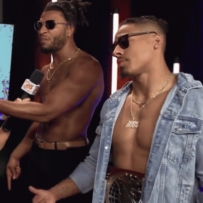 Shirtless Man With Jesus Necklace Next To Another GIF