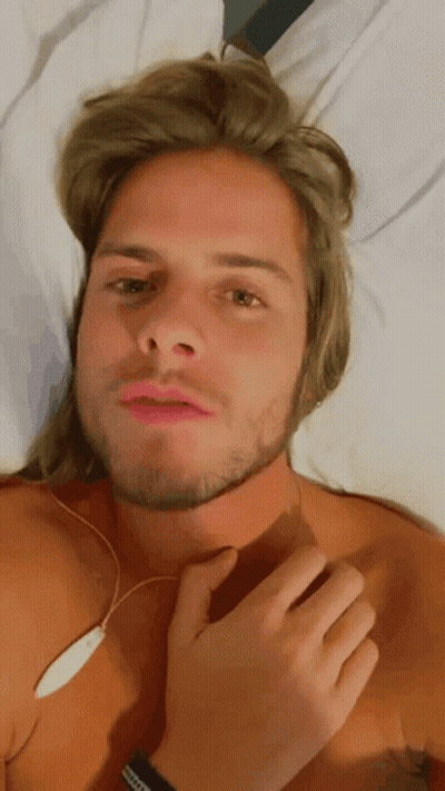 Shirtless Man With Long Blonde Hair And Beard Laying On Bed GIF