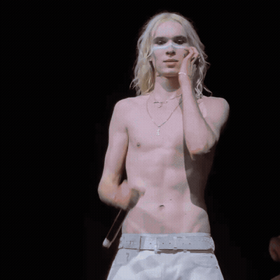 Shirtless Man With Long Blonde Hair And Cross Necklace GIF