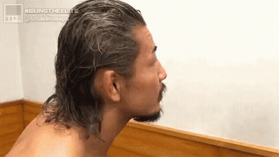 Shirtless Man With Long Hair And Beard Sitting On Wooden Bench GIF
