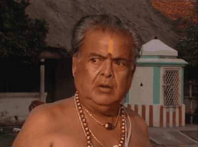 Shirtless Man With Necklace In Front Of Green Building GIF