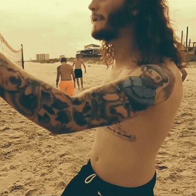 Shirtless Man With O'Neill Arm Tattoo GIF