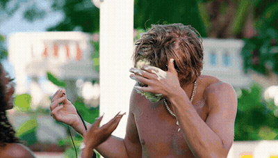Shirtless Man With Pearl Necklace Covering Face GIF