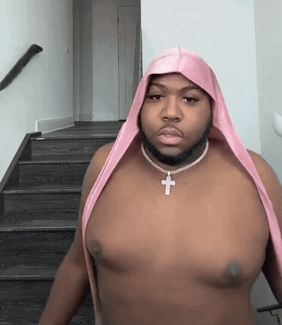 Shirtless Man With Pink Headband And Cross Necklace GIF