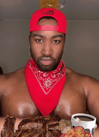Shirtless Man With Red Bandana And Hat Holding Beer On Head GIF