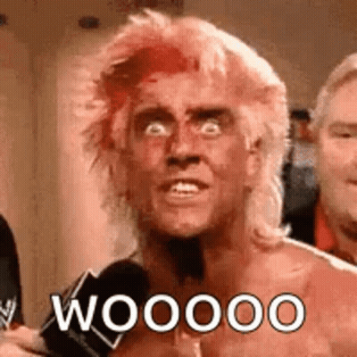 Shirtless Man With Red Hair Talking Into Microphone GIF