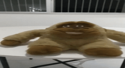 Shirtless Man With Sunglasses And Necklace On Yellow Couch GIF