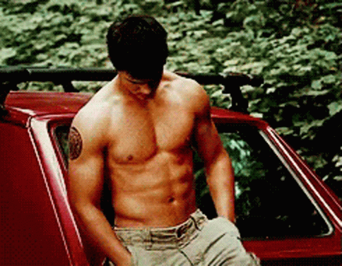 Shirtless Man With Tattoo In Red Car GIF