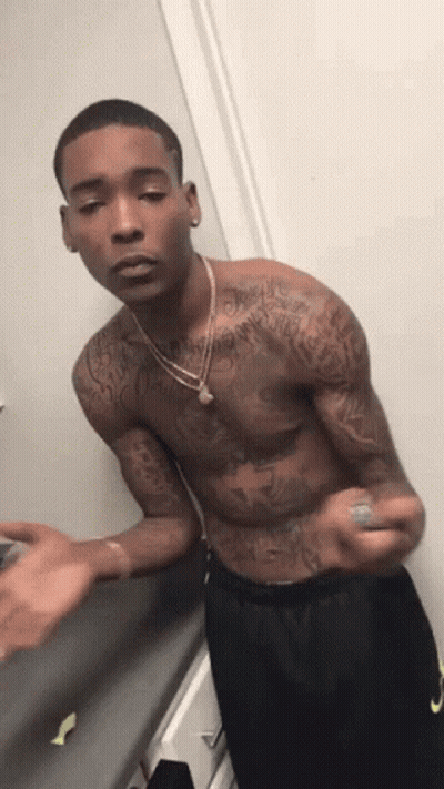Shirtless Man With Tattoos In Front Of Door GIF