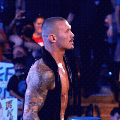 Shirtless Man With Tattoos Standing In Front Of Crowd GIF