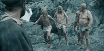 Shirtless Men Standing On Rocky Hillside GIF