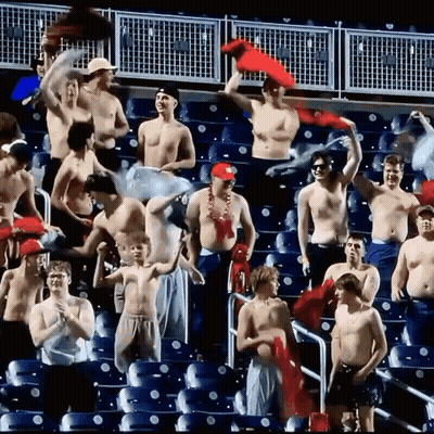 Shirtless Men Watching Game In Stadium GIF