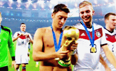 Shirtless Soccer Player Holding Trophy With Medal GIF