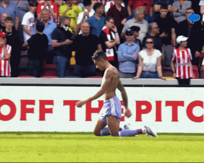 Shirtless Soccer Player Kneeling In Front Of Off The Pitch Sign GIF