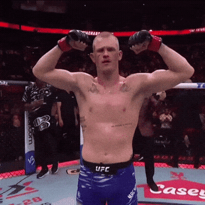 Shirtless UFC Fighter Flexing Muscles In Front Of Casey Sign GIF