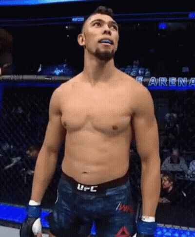 Shirtless UFC Fighter Standing In Cage Looking Up GIF