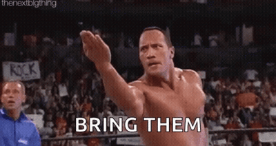 Shirtless Wrestler Arms Outstretched In Ring GIF