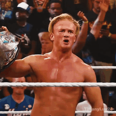Shirtless Wrestler Holding Championship Belt GIF