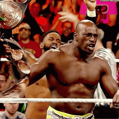 Shirtless Wrestler Holding Championship Belt In Ring GIF