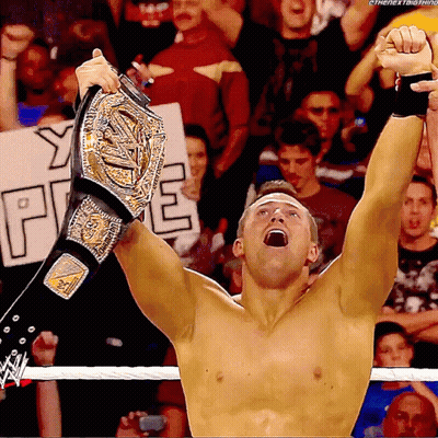 Shirtless Wrestler Holding Championship Belt GIF
