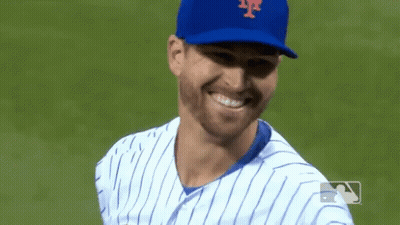 Shirtless Wrestler Holding Two Championship Belts GIF