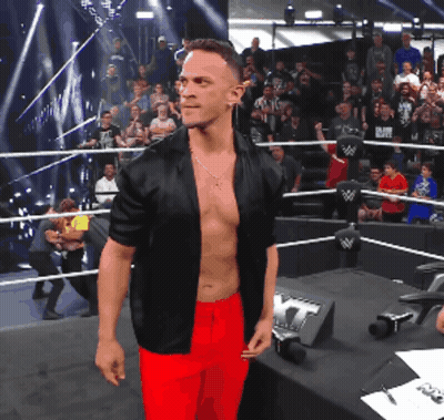 Shirtless Wrestler In Black Jacket And Red Pants GIF
