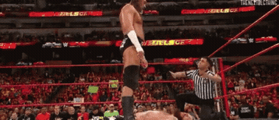 Shirtless Wrestler In Front Of Big Cass Sign GIF