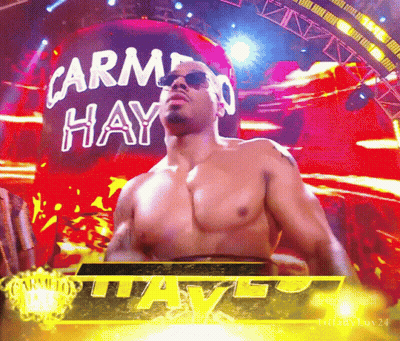 Shirtless Wrestler In Front Of Carmen Hay Sign GIF
