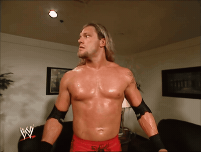 Shirtless Wrestler In Front Of Couch With W GIF