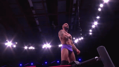 Shirtless Wrestler In Purple Shorts In Dark Room GIF