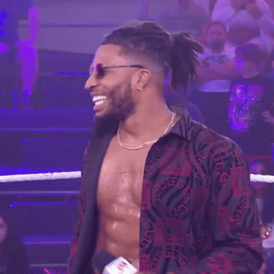 Shirtless Wrestler In Sunglasses And Necklace In Ring GIF