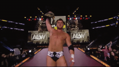 Shirtless Wrestler Interviewed With AEW Microphone GIF