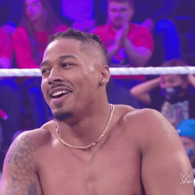Shirtless Wrestler Smiling In Front Of Crowd GIF