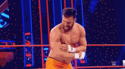 Shirtless Wrestler Standing In Ring With Wrestling Logo GIF