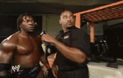 Shirtless Wrestler Talking To Another Man GIF