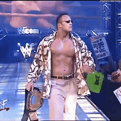 Shirtless Wrestler Walking Down Ramp Holding Drum GIF