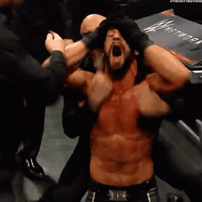 Shirtless Wrestler With Mouth Open Surrounded By People GIF