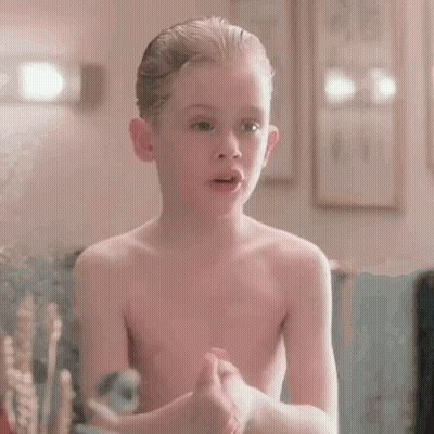 Shirtless Young Boy Covering Face In Mirror GIF