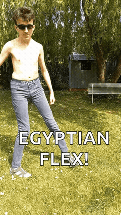 Shirtless Young Man Egyptian Flex In Grass GIF