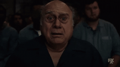 Shocked Man In Front Of Group With FX Logo GIF