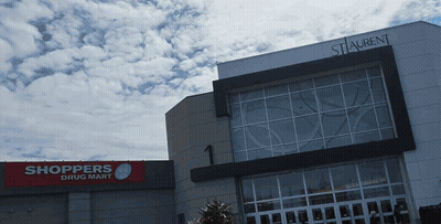 Shoppers Drug Mart In Front Of Large Building GIF
