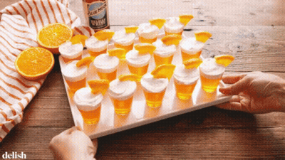 Shot Glasses With Orange Slices And Blue Moon GIF