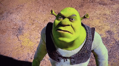 Shrek From The Movie Shrek Is Standing In The Desert Looking At The Camera With An Angry Look On His Face . GIF