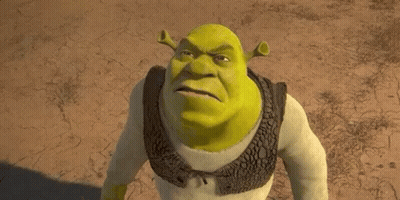 Shrek From The Movie Shrek Is Standing In The Dirt And Looking At The Camera . GIF