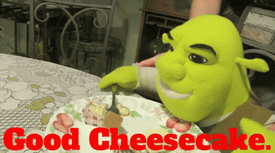 Shrek Is Eating A Cheesecake On A Plate With The Words Good Cheesecake Behind Him GIF