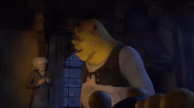 Shrek Is Giving A Thumbs Up To A Man In A Dark Room . GIF