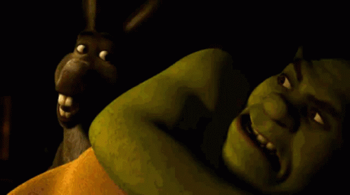 Shrek Is Laying On A Bed With A Donkey Behind Him GIF